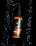 Small batch Caramelized Onion Bourbon Hot Sauce in rustic food styling setting