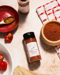 Smoked Brown Sugar seasoning from Ark Pepper Co being sprinkled over grilled food